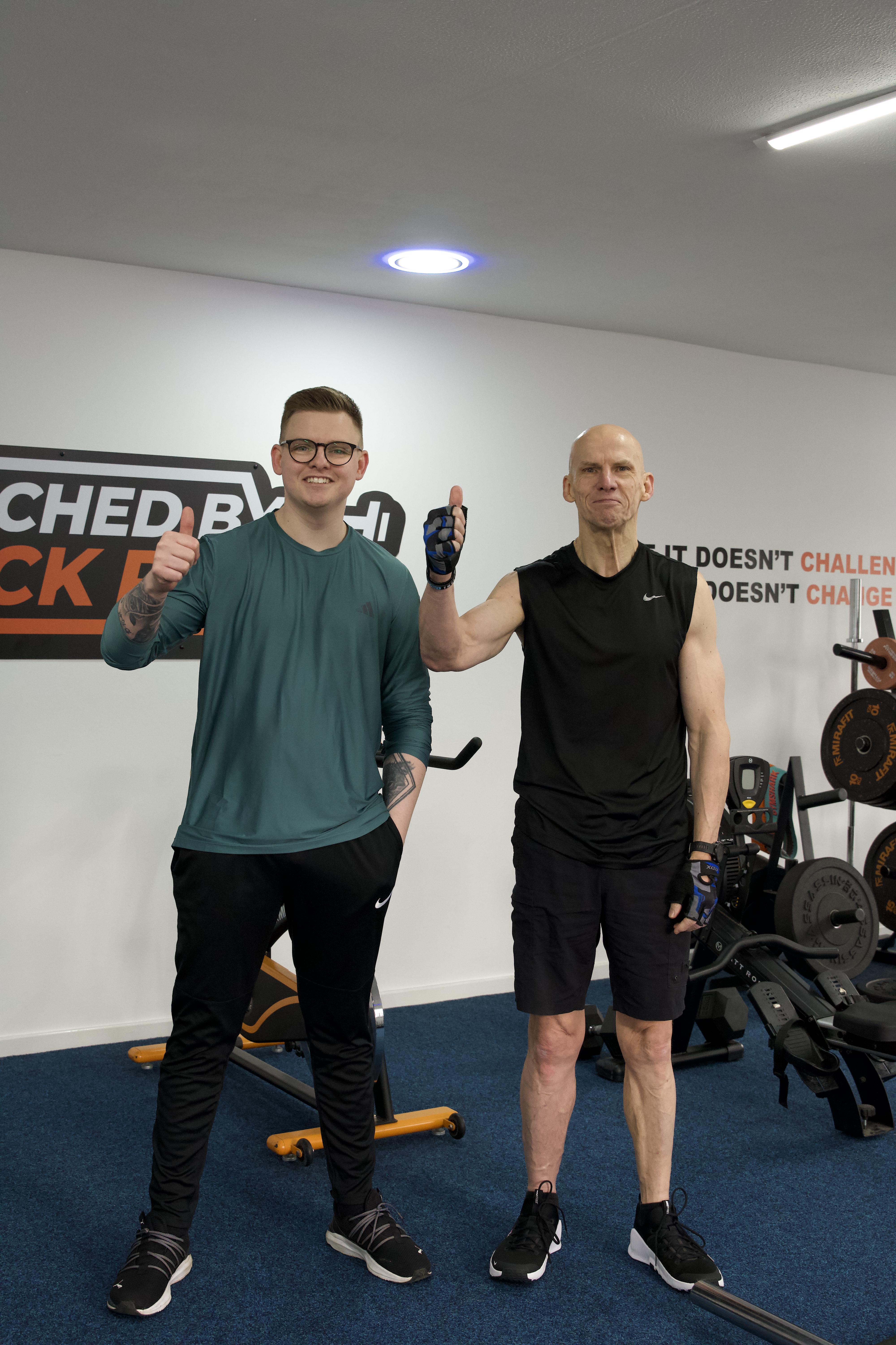Two clients giving thumbs up after a session